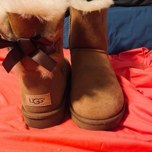 Tan bow back UGG boots.